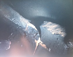 Close up of badly damaged flue tile heavy with sute found during an inspection using CMC video camera.