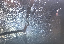 Close up of badly damaged flue tile heavy with sute found during an inspection using CMC video camera.